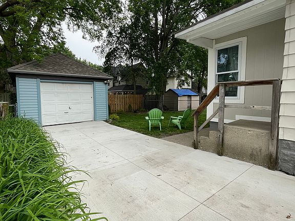 Shaded rear yard with fence and privacy, garage with electric opener