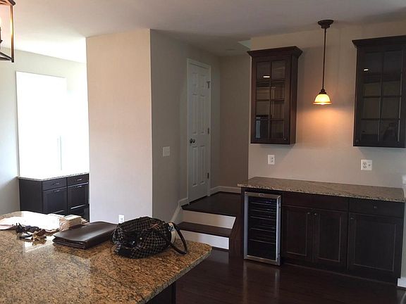 Dry bar with mini fridge, built in desk nook to the left, half bath