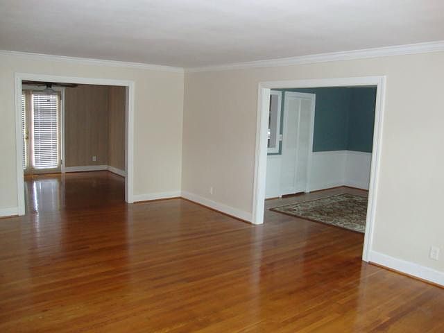 Living room view of dining room to right and "3rd" bedroom/den on left