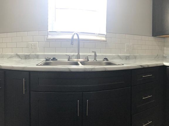 Cream/white tiled backsplash.