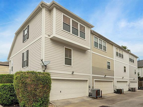 Double-car garage located in the back of the unit. Note that the third-story master bedroom has been extended over the garage compared to the other units in the complex.