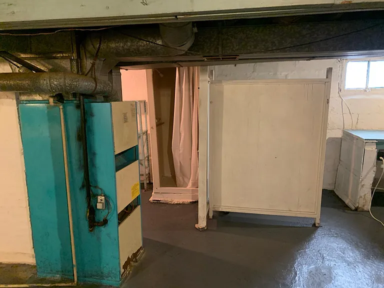 basement shower and toilet area, and the furnace.