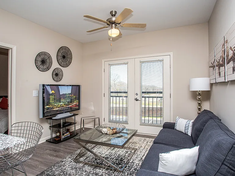 Cozy living area with private balcony access and plenty of natural light.