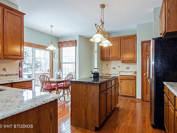 Beautiful 42" oak cabinets, island and planning desk, and a rear stairway!