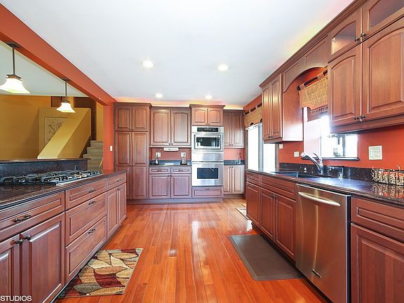 Gorgeous kitchen with cherry cabinets and cherry hardwood flooring