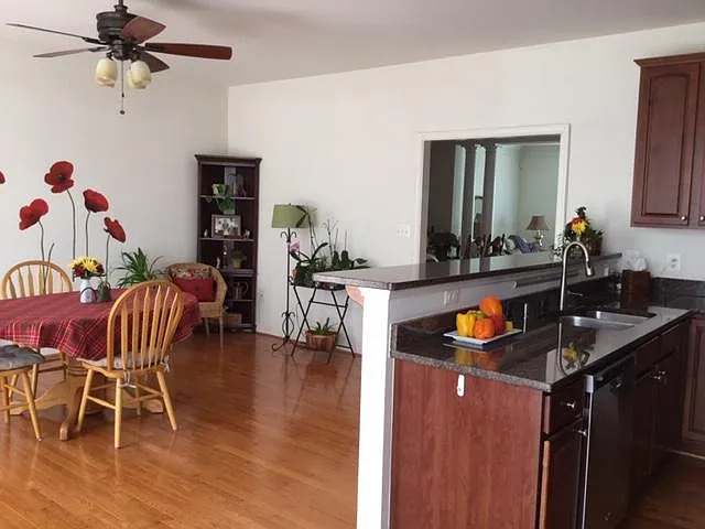 Family Room with large bar counter top with Ceiling Fan.