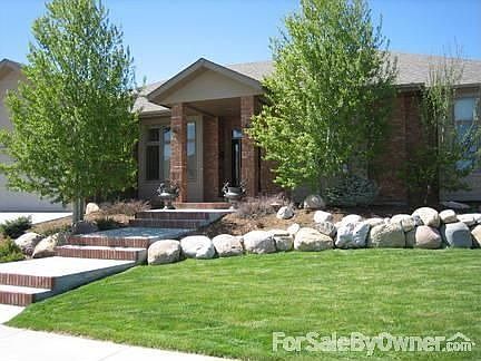 Front Exterior : South facing facade with mature landscaping and view of the mountains.