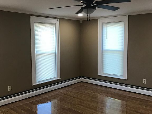 Living room has four floor to ceiling windows which provide so much natural light.