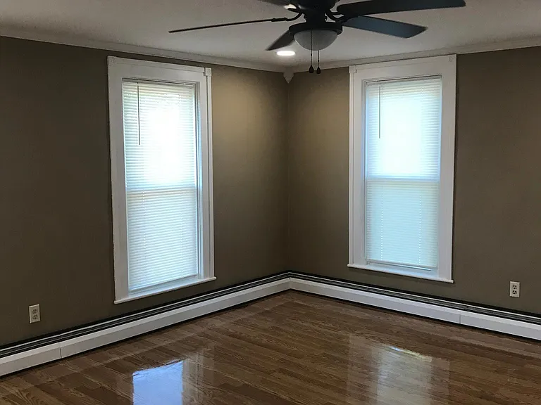 Living room has four floor to ceiling windows which provide so much natural light.