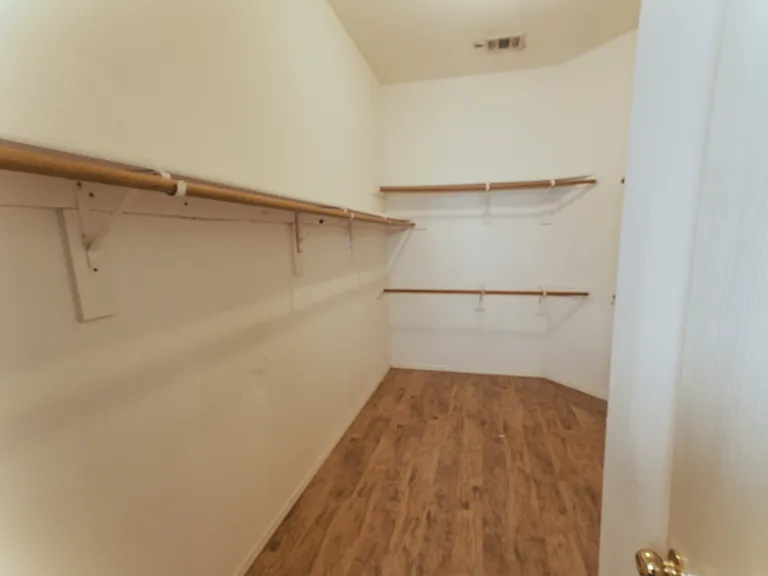 Never run out of space with this large walk-in closet, conveniently located off the primary suite for easy access