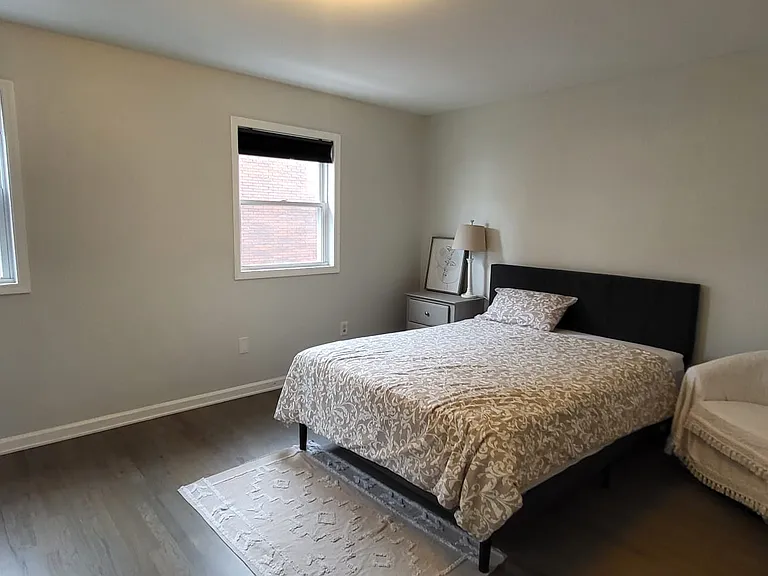 Primary bedroom with walk in closet, fully furnished with TV