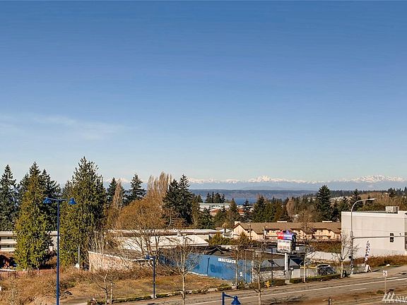 Large sliding glass door leads to a spacious balcony where you can appreciate the beautiful Puget Sound and Olympic Mountain views.
