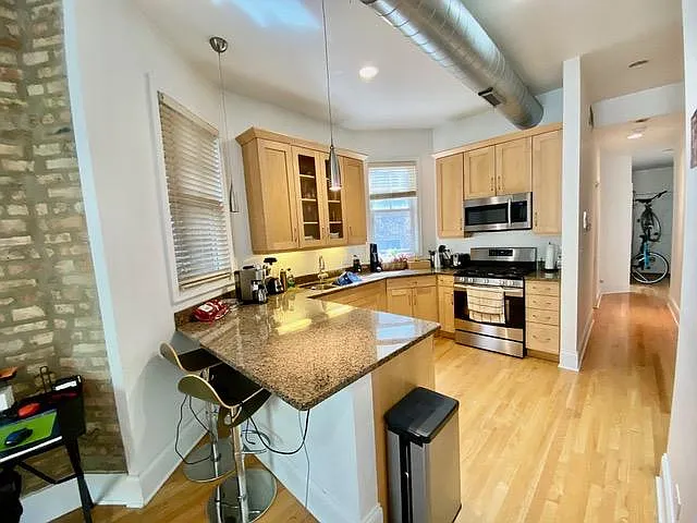 Kitchen with breakfast bar, stainless appliances, dishwasher