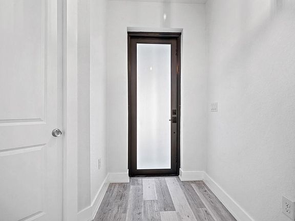 Front Entrance Door, high end laminate flooring through out this home. 8 foot doors with beautiful finishes
