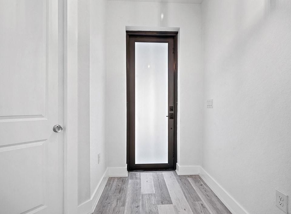 Front Entrance Door, high end laminate flooring through out this home. 8 foot doors with beautiful finishes