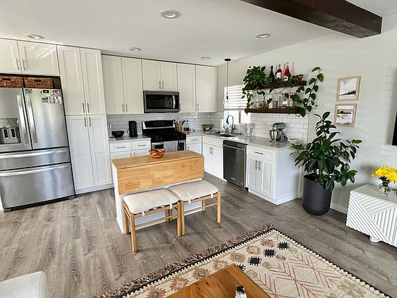 Shaker cabinets with plenty of storage, stainless appliances, gas stove, dishwasher, quartz countertops