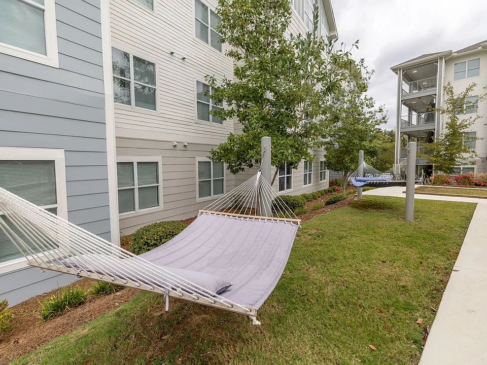 Relax and unwind in the peaceful hammock garden at The Flatts Starkville, offering a serene escape just steps from your student apartment.