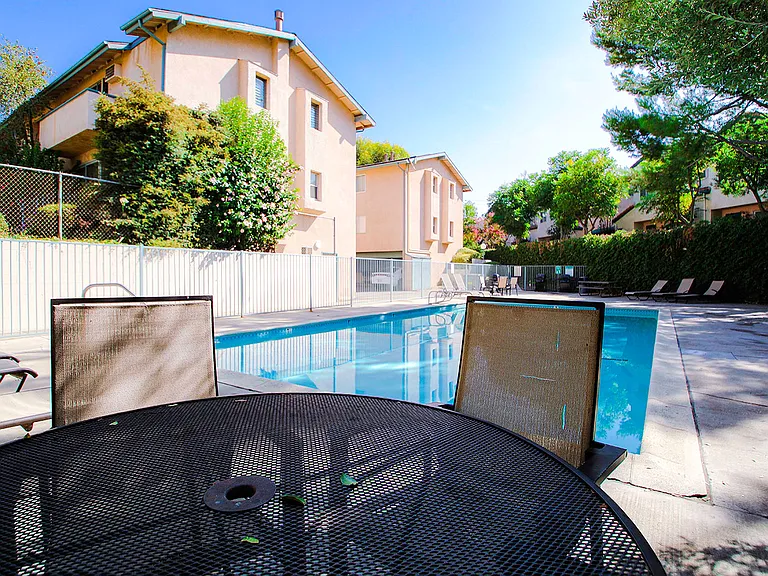 View of seating area by the pool at Olive View Gardens.