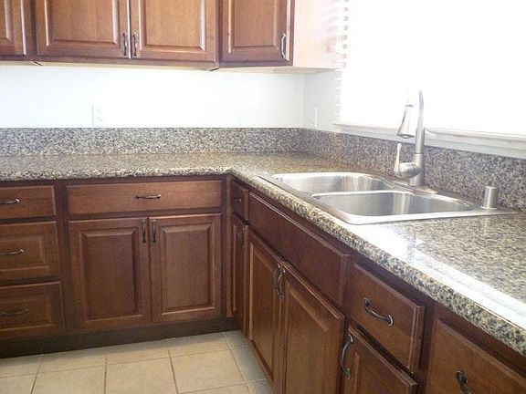Bright kitchen with cherry cabinets and granite counter tops