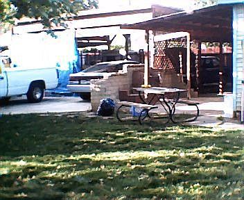 Back yard facing carports and shed also BBQ area
