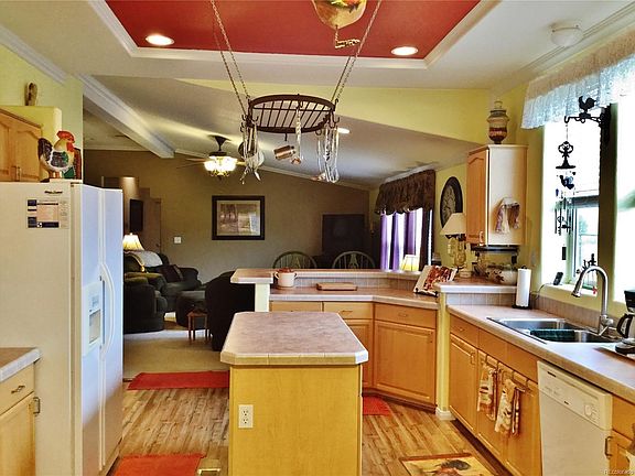 Country kitchen with updated cabinetry, new flooring and center island.