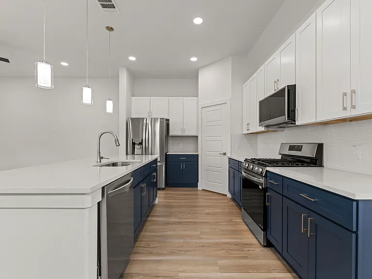 The kitchen has high-end appliances for the culinary enthusiast. The expansive pantry in the corner extends 10+ feet under the stairwell.