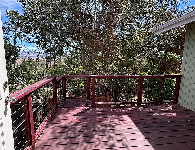 Back deck with stairs leading down to yard