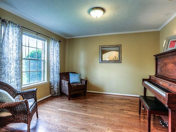 Dining room is currently being used as a piano room. Beautiful hardwood flooring allows it to be a D