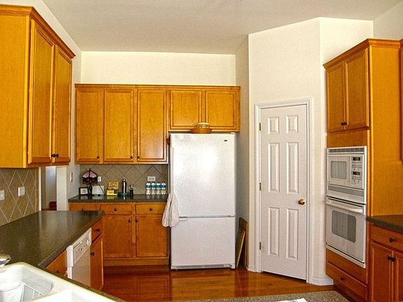 Kitchen has Matching White GE Appliances 