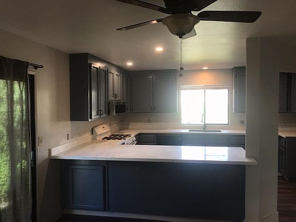 Updated kitchen cabinets and new quartz countertop, smooth surfaces for easy cleaning, bar style seating. Under mount stainless steel sink, garbage disposal and dishwasher. Gas cooktop and oven. New microwave installed over cooktop. Refrigerator available