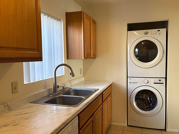 New kitchen cabinets, countertop, and full size washer and dryer. Tile floor