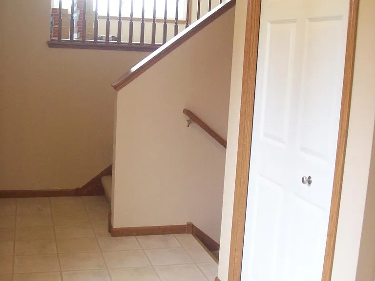 View into the home from the front door. Door from garage as well as a coat closet are in this entryway.