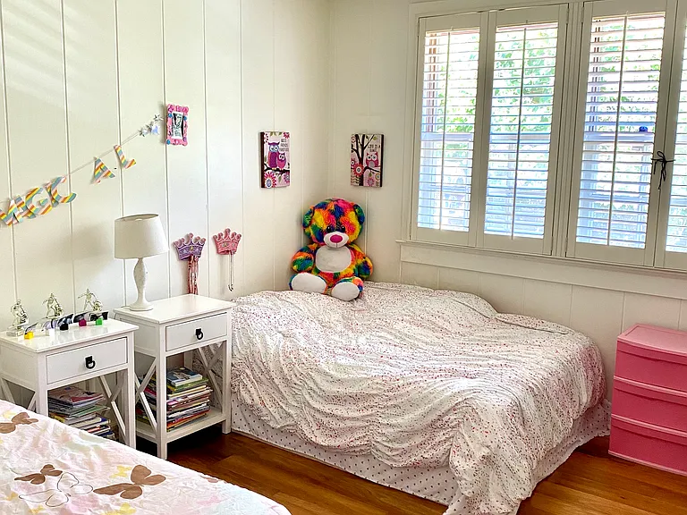 This bedroom has a split air conditioning unit and ceiling fan and shares a jack and jill bathroom with the other guest bedroom.