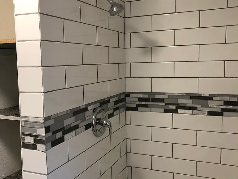 Shower head, to the left of the phot you can see additional storage area.