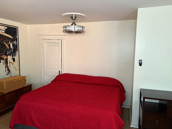 Bedroom with remote control ceiling fan and light