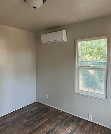 this is the back bedroom with closet and mini split heating and air conditioning unit