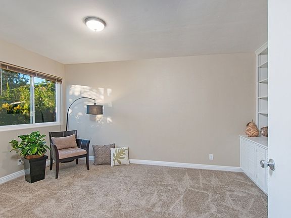 Entry level bedroom has had the closet removed and custom shelving, cabinets, and desk installed.  Overlooks the lovely front ya