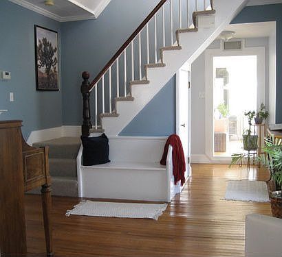 Music room with built in bench, carpeted stairs to second floor