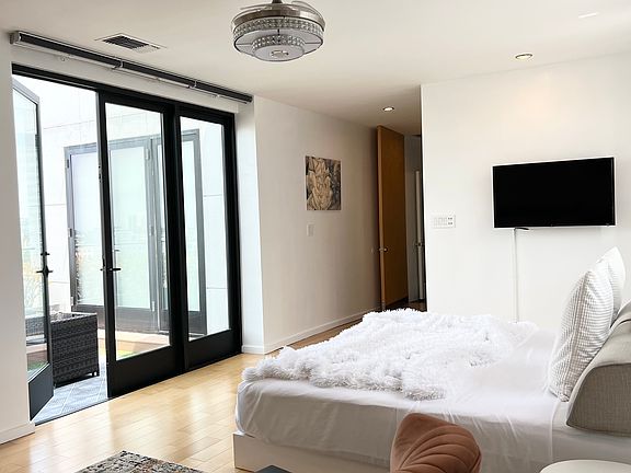 Lounge Area with TV, Bed, and Chair