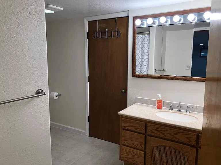 Door from Bath area to the laundry and storage area