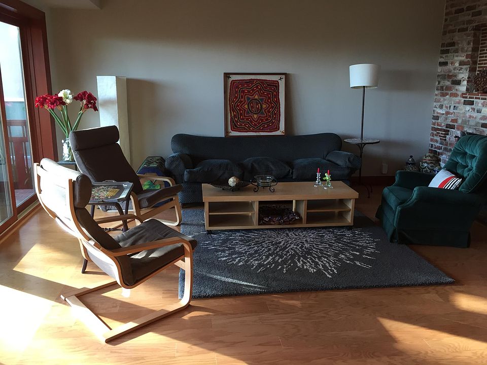 Living area with picture window giving to private deck. TV has replaced flowers on left.