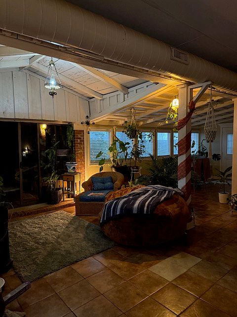 Living area. To the left is the extra room that can be used as office, playroom or hobby room. The area at the back right is commonly a dining area.