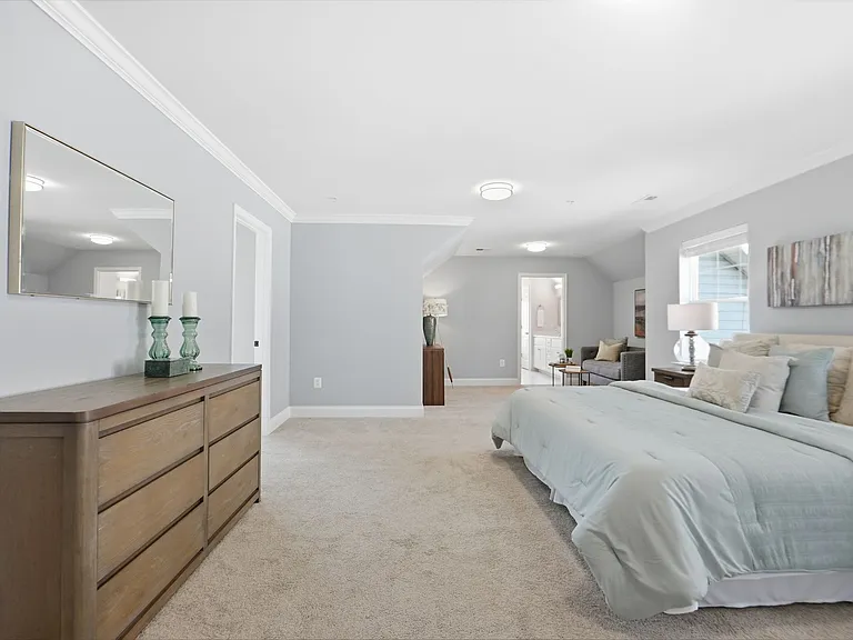 Master bedroom with sitting area, massive walk-in closet, and custom spa-like en-suite with soaking tub.