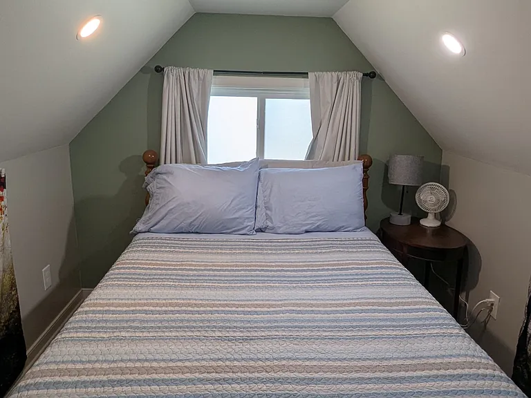 Upstairs, you'll find room to stand and a second bed for hosting guests, and the adjustable privacy curtains provide separation and light filtering. There is also a desk here to provide a dedicated work space with a great view