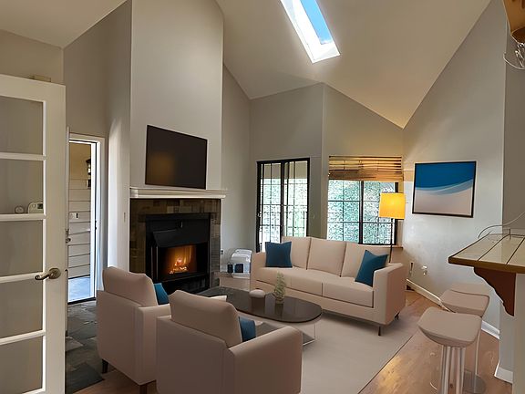 Cozy living space with open floor plan to kitchen