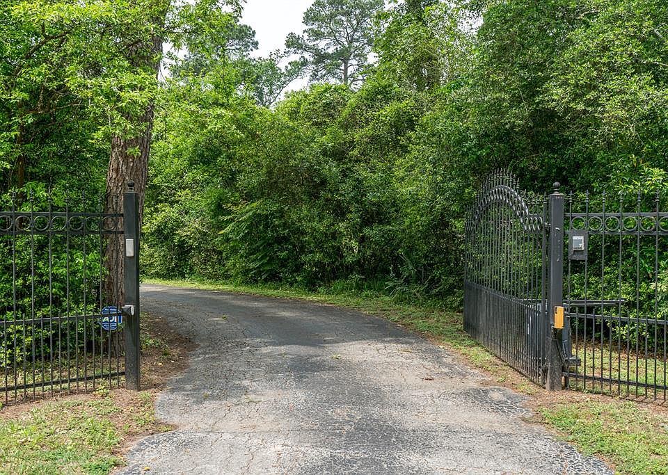 Private gates surrounded by natural landscape lead down a winding drive to your new home.