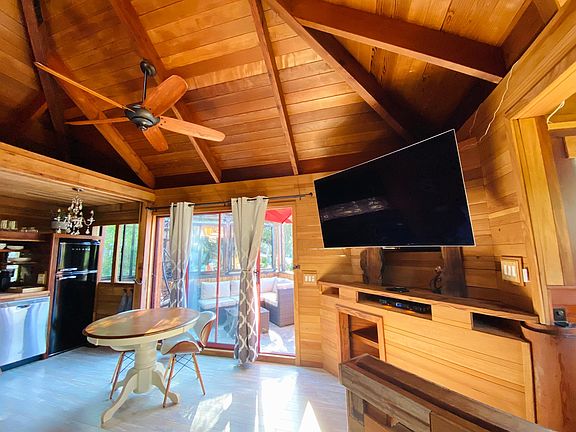 50_ HD TV with fire stick, above wooden round top table and chairs