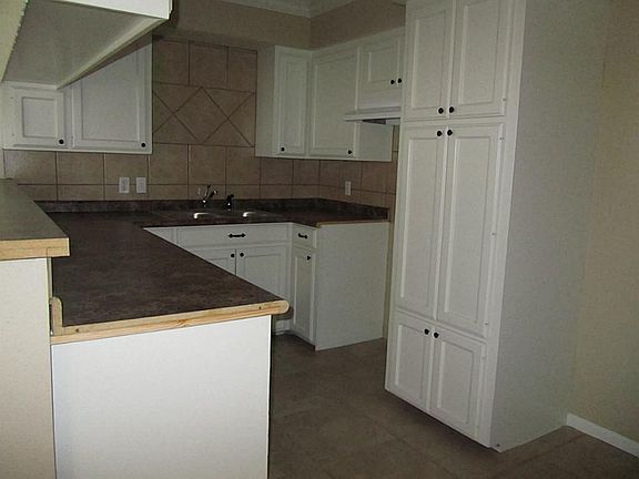 Laminate countertops and ceramic tile in kitchen.Stove and dishwasher will be connected before closing