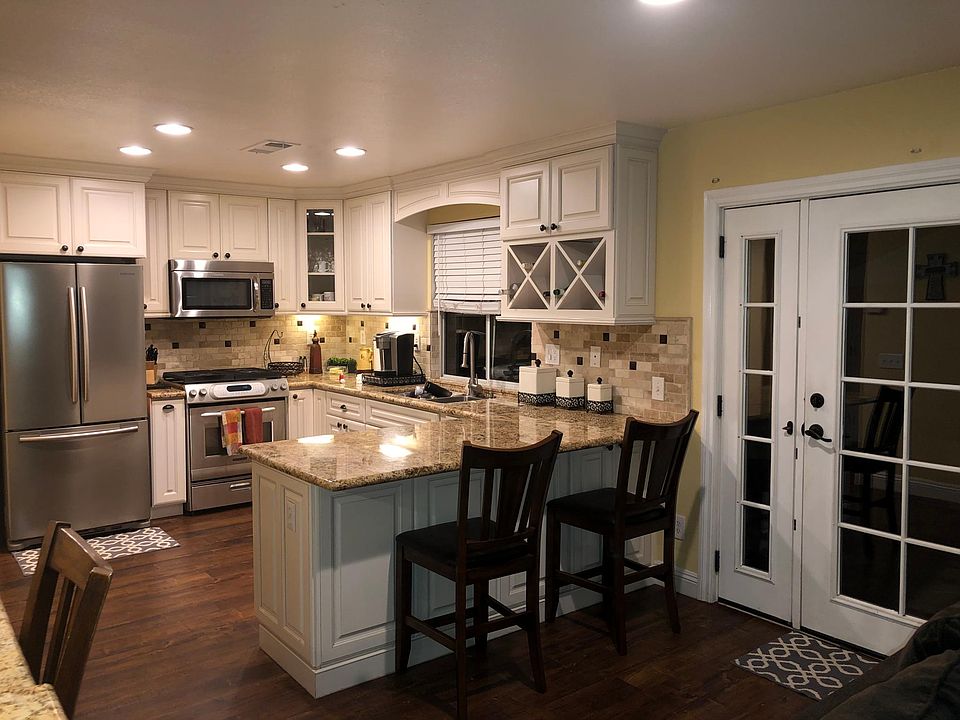 Remodeled kitchen with french doors that open up to the backyard
