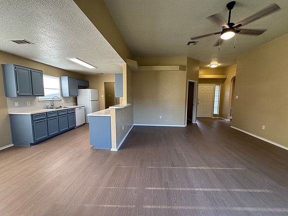 Vaulted ceiling and a wide picture window fill the great room with natural light while keeping sightlines to the kitchen and backyard.